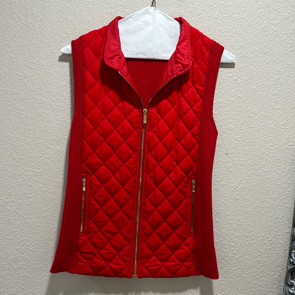 Red puffer vest, front gold zipper, pocket gold zippers.